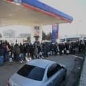 People wait in a line for petrol at a filling station in Kahramanmaras, Turkey on Tuesday. Christian Aid is providing blankets, mattresses and heating fuel to families in the region, including Northwest Syria, where four million people already needed help due to the long conflict (Photo by OZAN KOSE/AFP via Getty Images)