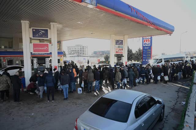 People wait in a line for petrol at a filling station in Kahramanmaras, Turkey on Tuesday. Christian Aid is providing blankets, mattresses and heating fuel to families in the region, including Northwest Syria, where four million people already needed help due to the long conflict (Photo by OZAN KOSE/AFP via Getty Images)