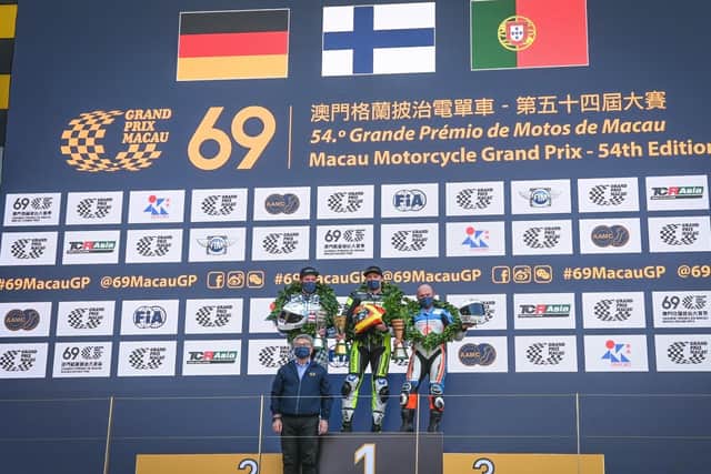 Macau Motorcycle Grand Prix winner Erno Kostamo on the rostrum with runner-up David Datzer and Sheridan Morais, who finished third.