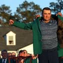 Scottie Scheffler is awarded the Green Jacket by 2021 Masters champion Hideki Matsuyama of Japan during the Green Jacket Ceremony after he won the Masters at Augusta National Golf Club on April 10, 2022 in Augusta, Georgia.