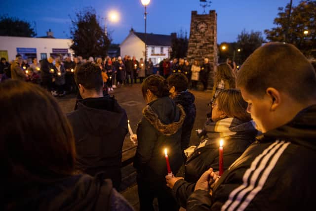 Mourners hold candles during a moment silence in Castlefinn, Co Donegal, at the vigil for victims of an explosion at the Applegreen filling station in Creeslough. PA Photo. Picture date: Sunday October 09 2022. See PA story IRISH Donegal. Photo credit should read: Liam McBurney/PA Wire