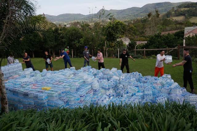 Volunteers pass water bottles for residents affected by a tropical cyclone on September 7, 2023 in Roca Sales, Brazil. The NI Assembly's environment committee has been told a similar emergency plan to supply vast amounts of bottled water may have to be deployed in Northern Ireland thanks to the Mobuoy waste dump