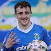 Linfield's Joel Cooper celebrates his four goals against Newry City with the match ball
