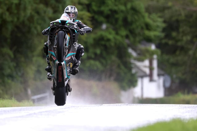Michael Dunlop wheelies his way through the rain on his way to his fifth win at the 2023 Armoy Road Races and his 10th 'Race of Legends' victory