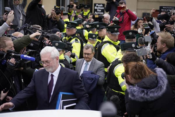 Former DUP leader Sir Jeffrey Donaldson leaving Newry Magistrates' Court on Wednesday, to a media scrum and verbal abuse from a waiting crowd. At one point it was unclear if police would be able to create a path to his vehicle. Photo: Niall Carson/PA Wire