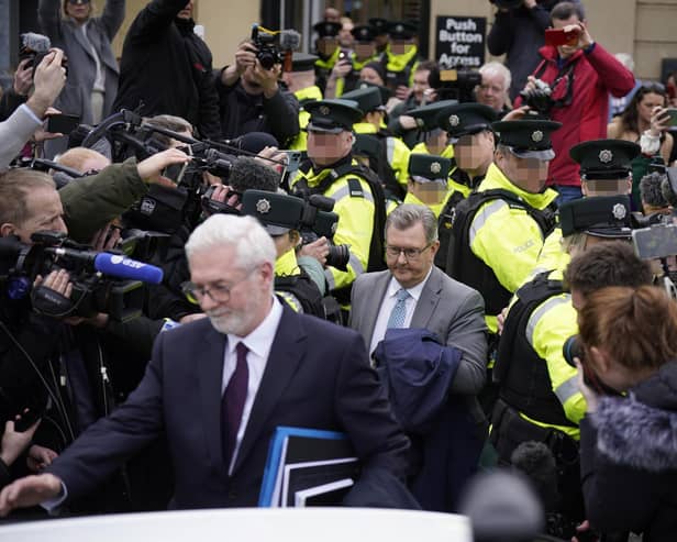 Former DUP leader Sir Jeffrey Donaldson leaving Newry Magistrates' Court on Wednesday, to a media scrum and verbal abuse from a waiting crowd. At one point it was unclear if police would be able to create a path to his vehicle. Photo: Niall Carson/PA Wire
