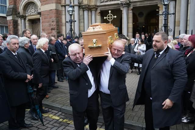 Photographers and members of the media make a Guard of Honour as the coffin of Olympic medallist boxer and press photographer Hugh Russell is taken from St Patrick's Church in Belfast, following his funeral. The 63-year-old died in the early hours of Friday following an illness. Photo: Brian Lawless/PA Wire