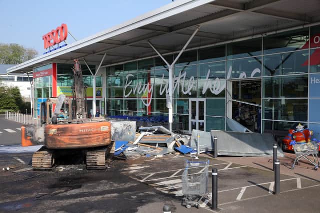 PACEMAKER, BELFAST, 19/4/2019: A burnt-out digger sits in front of the Tesco store in Crumlin, Co Antrim after an ATM robbery