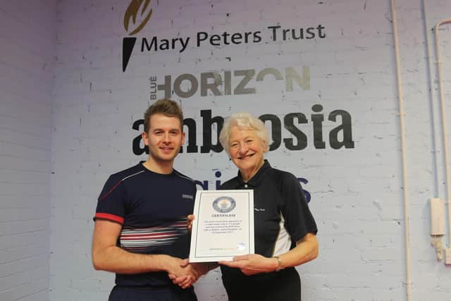 Ormeau Table Tennis Club are on a mission to claim back the Guinness World Record for the ‘Most consecutive opponents in a table tennis rally.’ Pictured is Keith Knox and Mary Peters with their certificate from September 2017