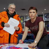 Community worker and activist Jamie Lee Mogey (left) at Carrickfergus Glasgow Rangers Supporters Club, with Lindsay Graham signing a letter calling upon elected representatives to keep their word and remain outside of Stormont until the Irish Sea Border has been removed. Picture: Liam McBurney/PA Wire