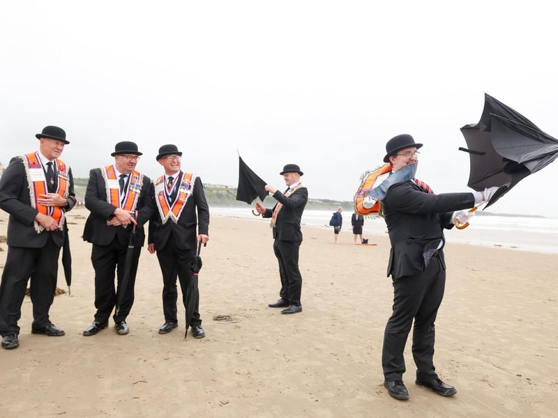 Brother Samuel Douglas district Lay Chaplin from the Loughbrickland District pictured having trouble with his umbrella on the beach
