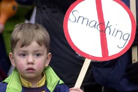 A young child holding an anti-smacking placard on the march to Downing Street in 2004. Photo: Rebecca Naden/PA Wire