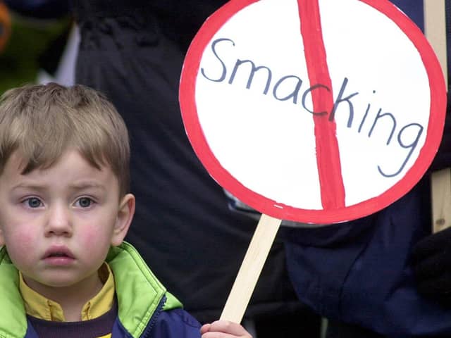 A young child holding an anti-smacking placard on the march to Downing Street in 2004. Photo: Rebecca Naden/PA Wire