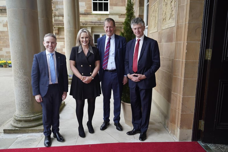 Alastair Campbell (2nd right) and Jonathan Powell (right) is welcomed by Laura McCorry of Hillsborough Castle and Ryan Feeney (left) of Queen's University at a Gala dinner to recognise Mo Mowlam's contribution to the peace process and to mark the 25th anniversary of the Good Friday Agreement at Hillsborough Castle in Northern Ireland.