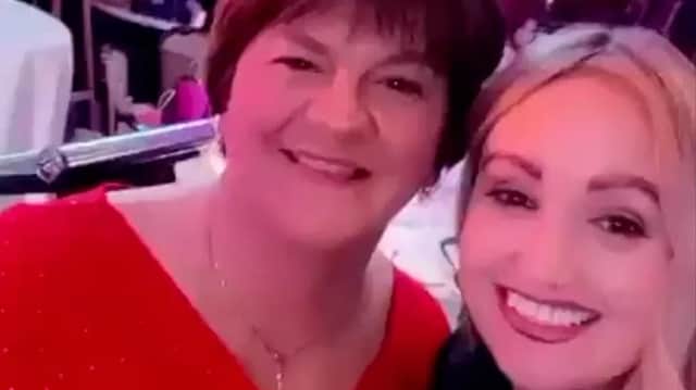An image of the woman, since identified as Sinead Murtagh, and Arlene Foster, whom she encouraged to pose wit her before singing 'Up the Ra'