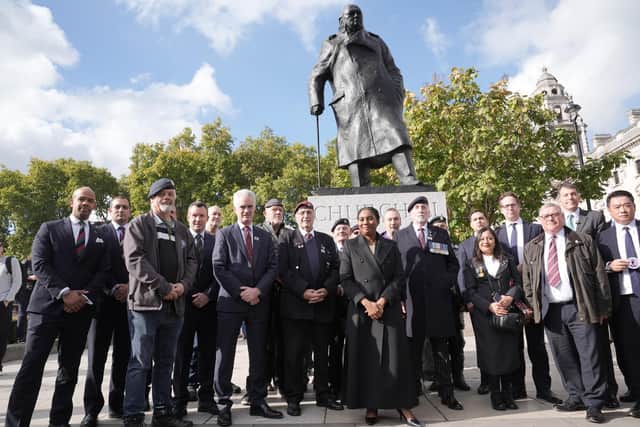 Conservative Party leader Kemi Badenoch (centre) meets armed forces veterans under a statue of Sir Winston Churchill in Westminster, as the government's Troubles Bill enters the report stage. Photo:: Stefan Rousseau/the Press Association