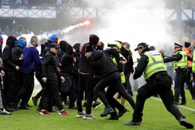 Police officers and stewards force fans back after a pitch invasion at Ibrox on March 8 in the Scottish Cup quarter-final match between Rangers and Celtic. (Photo by Steve Welsh/PA Wire)