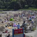 People enjoy the warm weather at Helen’s Bay beach in the summer