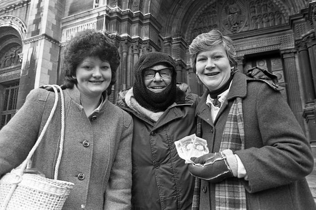 Mrs Eilish Joss, left, and her sister, Mrs Ann McLoughlin, both of North Queen Street, Belfast, pictured in December 1982 with the Dean of Belfast, the Very Reverend Samuel Crooks, outside St Anne’s Cathedral, as they donate money to his Christmas appeal for charities. Picture: News Letter archives