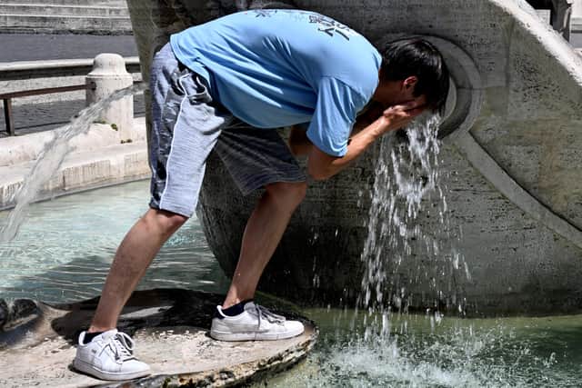 A boy cools down at the Barcaccia fountain in front of the Scalinata di Trinita dei Monti (Spanish Steps) in Rome on July 17, 2023, during a heatwave in Italy. Photo by TIZIANA FABI/AFP via Getty Images