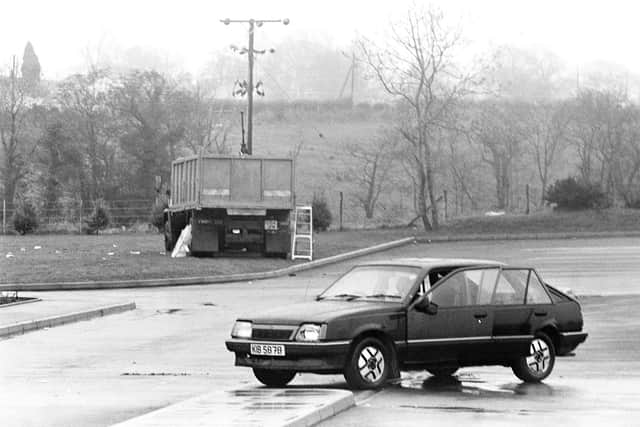 The scene after the February 1992 Clonoe incident, including an abandoned getaway car and the hijacked heavily armed lorry used by the IRA gang in their police station attack. Picture: Pacemaker Belfast Archive.