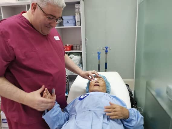 Professor Colin Willoughby after performing surgery on a patient in Cambodia in 2019