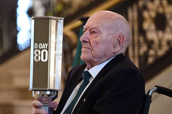 D-Day landings veteran George Horner with a beacon lit to symbolise the 'passing of the torch’ to a new generation. Photo: Michael Cooper