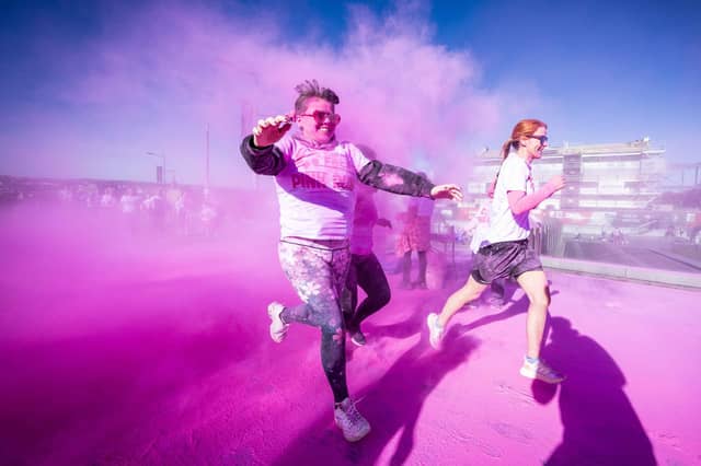 Runners, walkers, and pooches were splashed in pink powder from head to toe for a great cause as Cancer Focus NI’s first Pink Run took place in Londonderry. Picture Steven McAuley/McAuley Multimedia