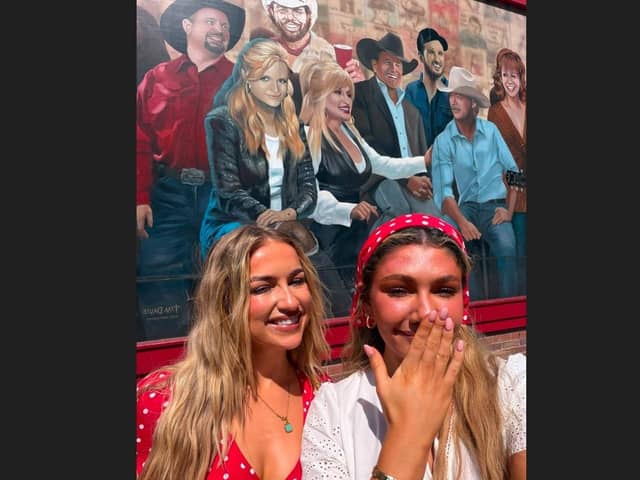 ​Ellen Watson (left) and Beth McDaniel from Banbridge at a mural featuring Dolly Parton (centre back) in Nashville just after her death.