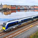 A Translink train passing by the River Foyle