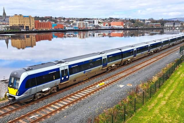 A Translink train passing by the River Foyle