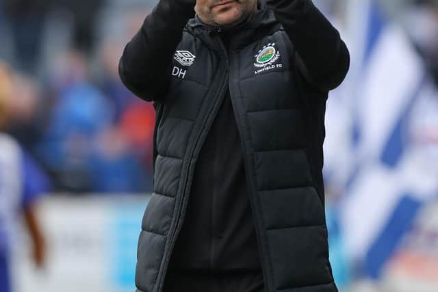 Linfield manager David Healy applauds the fans