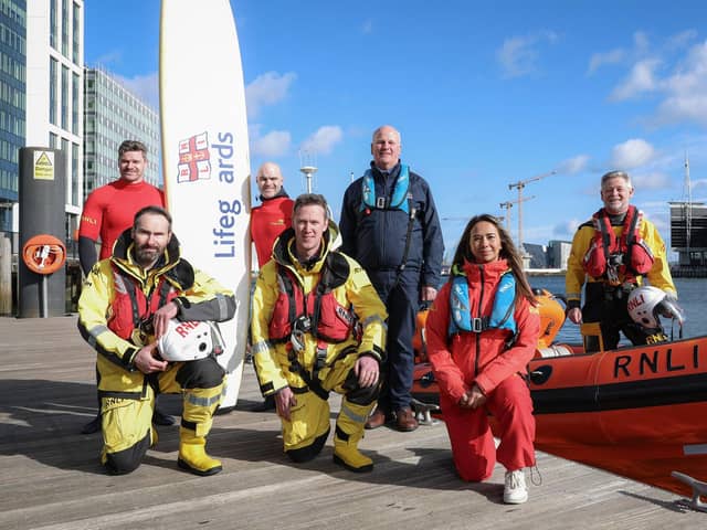 From left, RNLI Lifeguard Supervisors Karl O'Neill and Conard McCullagh, RNLI Trustee Paddy McLaughlin, and Kevin Allen, Red Bay RNLI Lifeboat Operations Manager. Kneeling, from left, volunteers Phil Ford-Hutchinson from Larne and Ben Durrant from Portrush alongside Lifeguard Supervisor Annie Jagoe