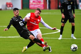 Aaron Donnelly of Larne tackles Nazmi Gripshi of Ballkani. PIC: Andrew McCarroll/Pacemaker Press