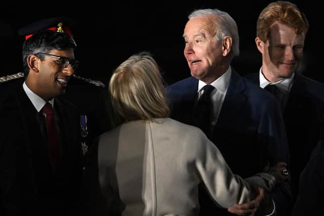 US President Joe Biden reacts as he is greeted by Britain's Prime Minster Rishi Sunak (L) after disembarking from Air Force One upon arrival at Belfast International Airport on April 11, 2023. (Photo by JIM WATSON/AFP via Getty Images)