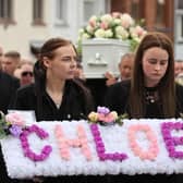Chloe Mitchell's sisters Kirstie (left) and Nadine carry a wreath in front of her coffin as it is carried along Larne Street, in Ballymena. Photo: Liam McBurney/PA Wire