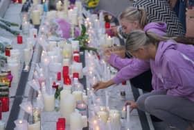 People light candles at the end of Sunday's vigil in Kickham Plaza, Co Tipperary, in memory of Luke McSweeney, 24, his 18-year-old sister Grace McSweeney, Zoey Coffey and Nicole Murphy, both also 18, who died while on the way to celebrate exam results after the car they were travelling in struck a wall and overturned in Clonmel on Friday. Pic: Brian Lawless/PA Wire
