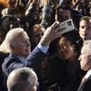 President Joe Biden takes a photo with people in the crowd at a campaign event in New York