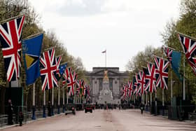 Union flags hang near Buckingham Palace on the Mall, London, yesterday ahead of the coronation. We are a country made up of increasingly vast numbers of immigrants and one of the most important things we can give them is, as King Charles is doing on Saturday, to make them welcome and part of this ancient fabric. Photo: Jordan Pettitt/PA Wire