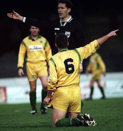 Leslie Irvine, pictured as referee in the late 1990s, has been recognised with an MBE