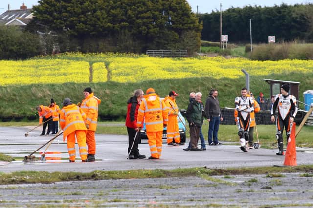 J McC Roofing Racing riders Jason Lynn and Adam McLean inspect the track following a heavy period of rain and hail at Kirkistown on Easter Monday.