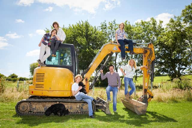 Whole family posing on a digger