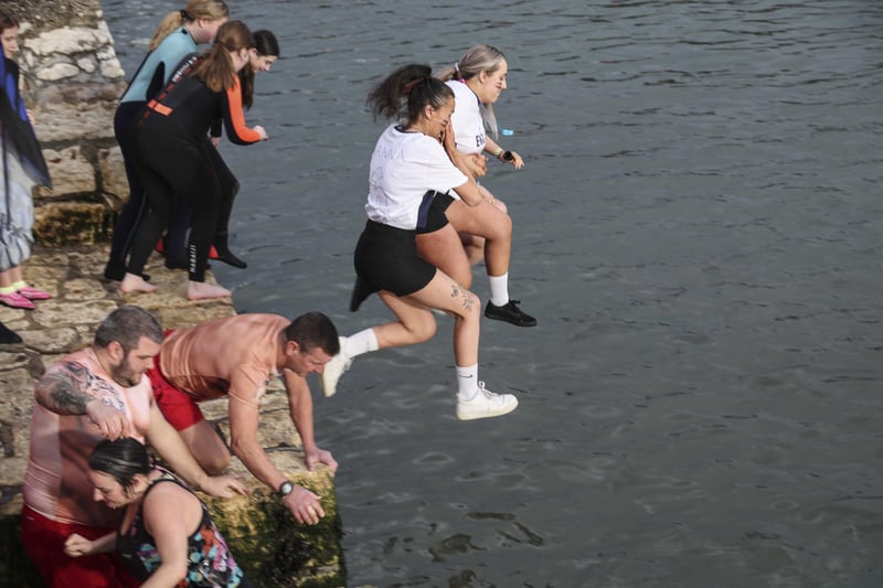 Leaping into 2023 at the annual New Year's Day swim in Carnlough, Co. Antrim. 
Pic Pacemaker