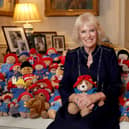 The Queen Consort with a collection of Paddington cuddly toys in the Morning Room at Clarence House, on the 64th anniversary of the publication of the first Paddington bear book. Over 1,000 Paddington and teddy bears, left at at Royal Residences as tributes to Queen Elizabeth II, will be donated to the Barnado's charity.