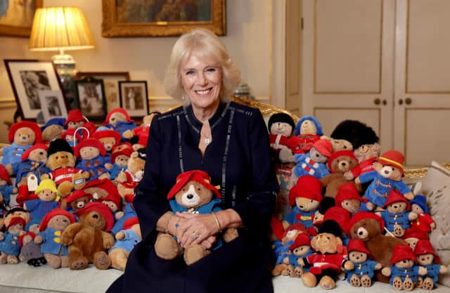 The Queen Consort with a collection of Paddington cuddly toys in the Morning Room at Clarence House, on the 64th anniversary of the publication of the first Paddington bear book. Over 1,000 Paddington and teddy bears, left at at Royal Residences as tributes to Queen Elizabeth II, will be donated to the Barnado's charity.