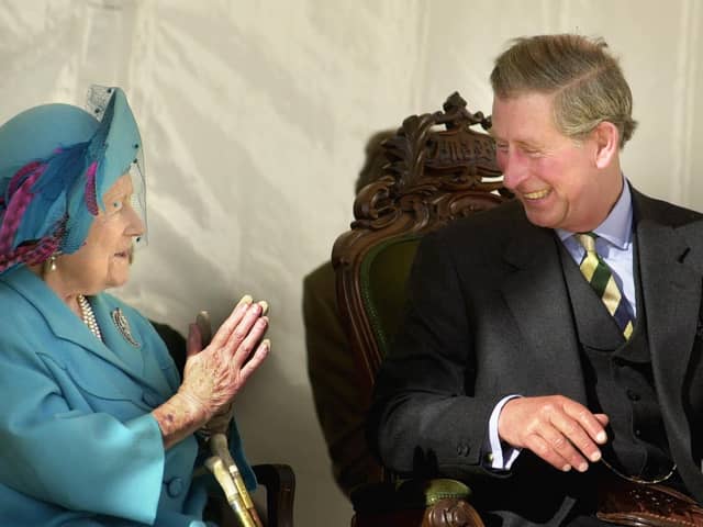 The Queen Mother shares a joke with her grandson Prince Charles, known as the Duke of Rothesay in Scotland, during the unveiling of an Aberdeen Angus sculpture at the Alford Transport Museum.   *The bull sculpture, created by artist David Annand, is a tribute to the generations of stockmen who established the breed. :PA:King Charles lll