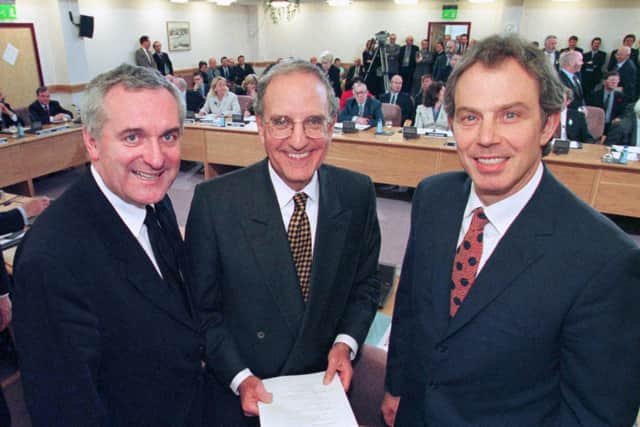 Prime Minister Tony Blair (right), US Senator George Mitchell (centre) and Irish Prime Minister Bertie Ahern after they signed the Good Friday peace agreemen