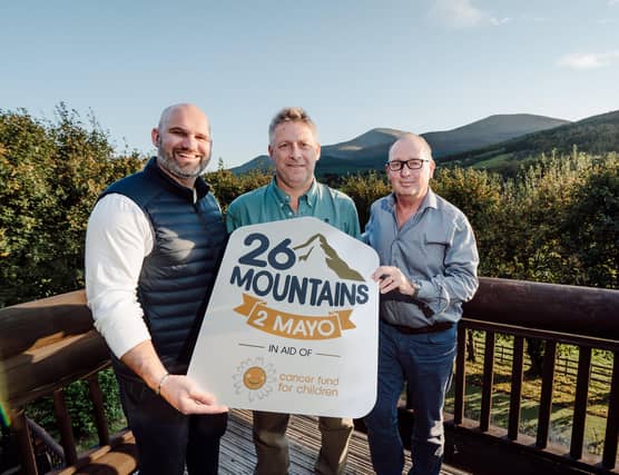 CEO of Cancer Fund for Children, Phil Alexander, challenge organiser and CEO of Axial 3D in Belfast, Roger Johnston and challenge participant and managing director of CRN Financial Group, Graeme Neill, against the backdrop of the Mourne Mountains