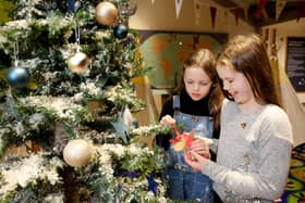 Isobel and Maisie decorate the Christmas tree