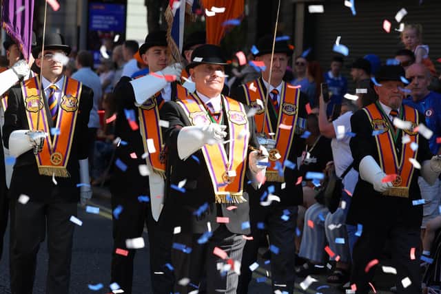 Orangemen stride through a hail of confetti in Belfast city centre for the Twelfth 2025 (Jonathan Porter/PressEye)